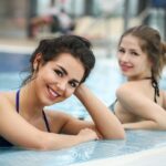 pexels-photo-3775163-3775163 Memorial Pool Services customers Two young women smiling and relaxing in an indoor swimming pool. Perfect for lifestyle and leisure themes.